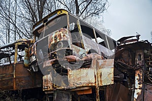 Scrap of abandoned and forgotten old rusty bus in forest