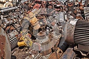 Scrap with electric motors and rusty metal parton scrap heap ready for recycling