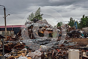 Scrap metal on junk. Old rusty damaged cars and machine parts.