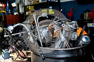 Scrap metal for junk removal in a mechanic automobile repair shop. Car parts for recycling metal
