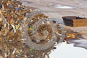 Scrap mountain on a puddle