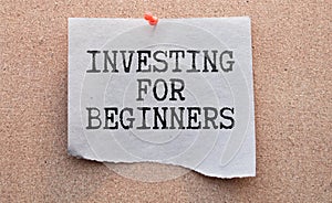 a scrap of paper with INVESTING FOR BEGINNERS written on it.