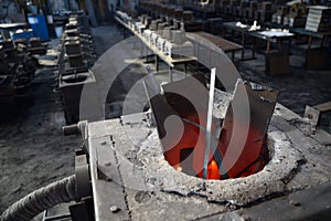 scrap steel melts down in an induction furnace at a small foundry photo