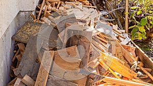 Scrap wood and lumber cuttings for firewood or junk removal service, in a pile. Useful for recycling projects or firewood, as
