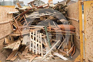 Scrap wood in a recycling skip.