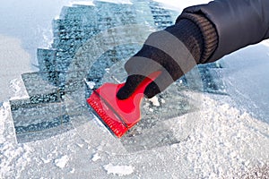 Scraping ice from the car