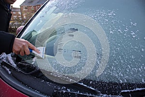 Scraping ice off a car window