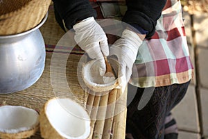 Scraping or pruning endosperm of coconut manually