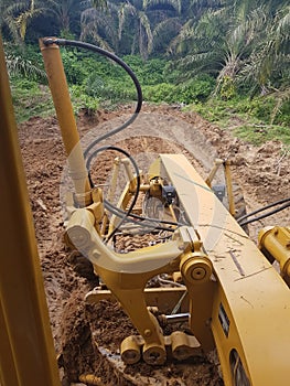 Scrapper of Road in the Palm Oil Estate