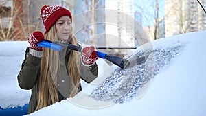 Scrapping frozen car windscreen with ice scraper