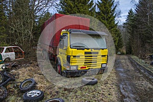 Scrapyard for cars (yellow truck)