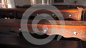 Scratched inscriptions on wooden church benches in the church