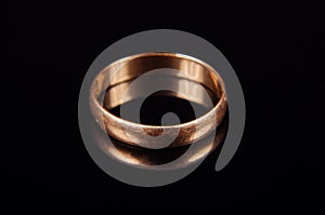 Scratched wedding ring isolated on the black background