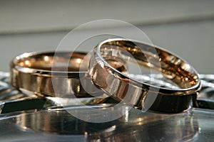 scratched wedding rings on a shiny metal surface. selective focus