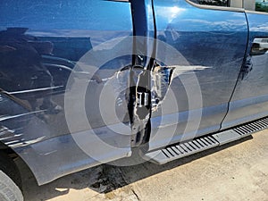 scratches and damage on paint on blue truck vehicle