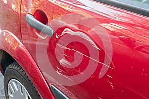 Scratches on the red car