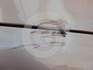 Scratches scrapes dings and dents on car