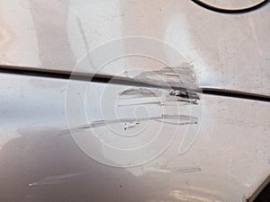 Scratches scrapes dings and dents on car