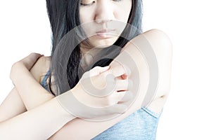 Scratching her arm or shoulder in a woman on white background. Clipping path on white background.