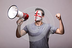 Scream on megaphone Englishman football fan in game supporting of England national team