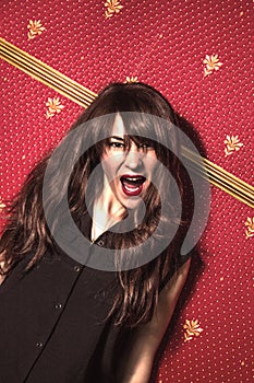 Scream. Woman screaming wild and crazy at full energy looking at