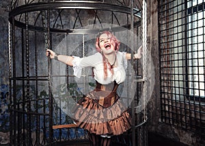 Screaming beautiful steampunk woman in the cage