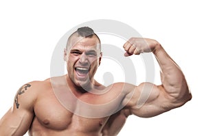 Screaming bodybuilder flexing arm. Shirtless excited muscular healthy young man flexing his biceps internal side.