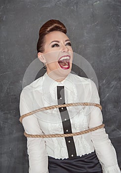 Screaming business woman tied with rope