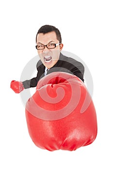 Screaming businessman attack to enemy with boxing gloves