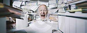 Screaming businessman drowning under a lot of paperwork