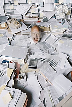 Screaming businessman drowning under a lot of paperwork