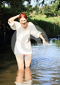 Screaming girl in blouse in water