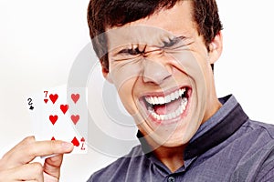 Screaming guy with bad playing cards