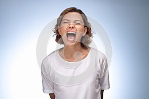 Screaming, Hate, Rage Emotional Portrait of Angry Woman in Studio