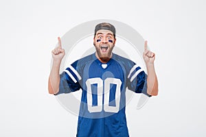 Screaming man fan in blue t-shirt pointing.