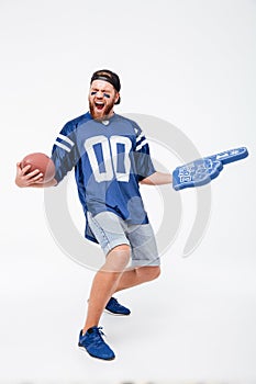 Screaming man fan in blue t-shirt standing isolated