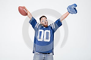 Screaming man fan in blue t-shirt standing isolated