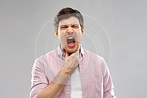 Screaming man suffering from sore throat