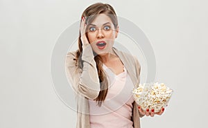 Screaming scared woman holding popcorn