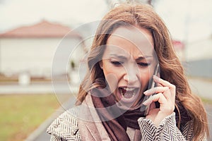 Screaming woman having phone converstation outside