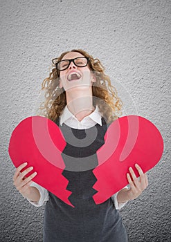 Screaming woman holding broken heart