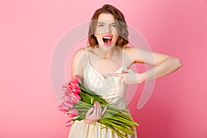 screaming woman pointing at bouquet of pink tulips
