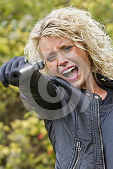 Screaming woman shooting from handgun