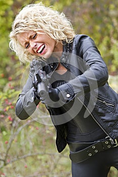 Screaming woman shooting from machine gun