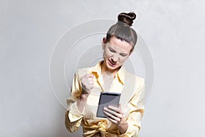 Screaming young girl playing video games on smartphone.