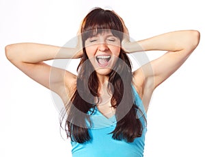 Screaming young woman holding head