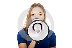 Screaming young woman with megaphone.