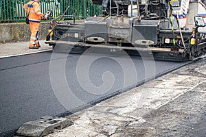 Screed of asphalt paver makes smooth asphalt mat - road reconstruction