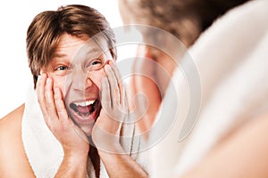 Screeming Man applying lotion after shaving