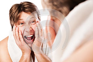 Screeming Man applying lotion after shaving photo